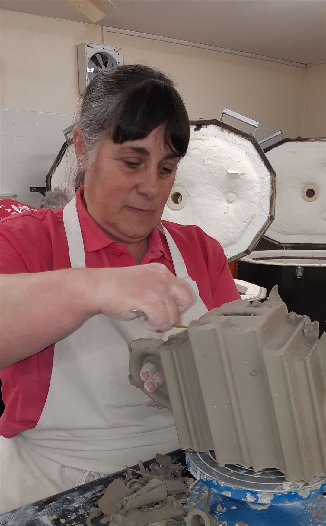 Jill Davey trims excess clay from a newly-moulded teapot
