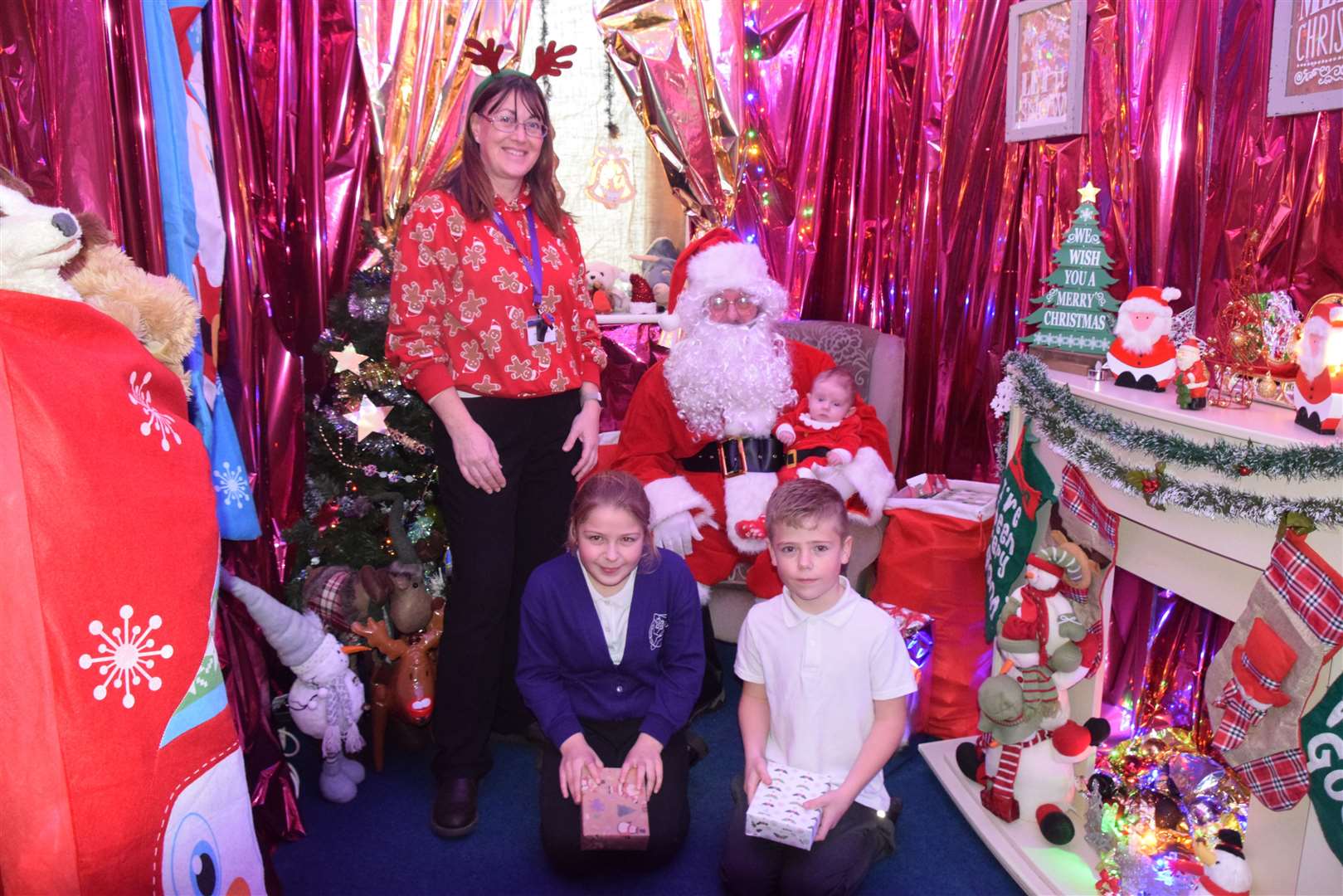 Headteacher Lorraine Ratcliffe and Father Christmas with children from one of the School's families. Picture: Lorraine Ratcliffe