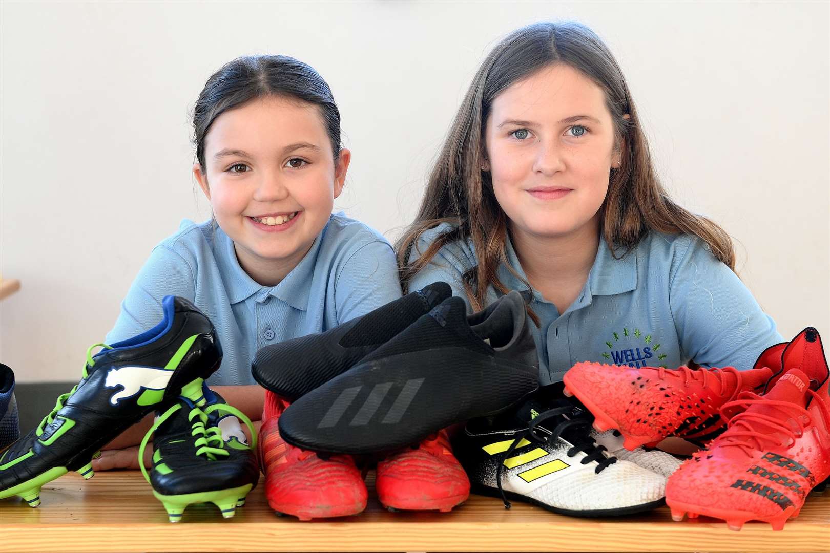Pupils from Wells Hall Primary School with some of the donated boots. Picture: Mecha Morton