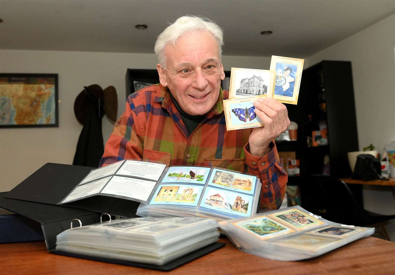 Rob Butterworth with some of his collection books of tea cards. Picture: Mecha Morton