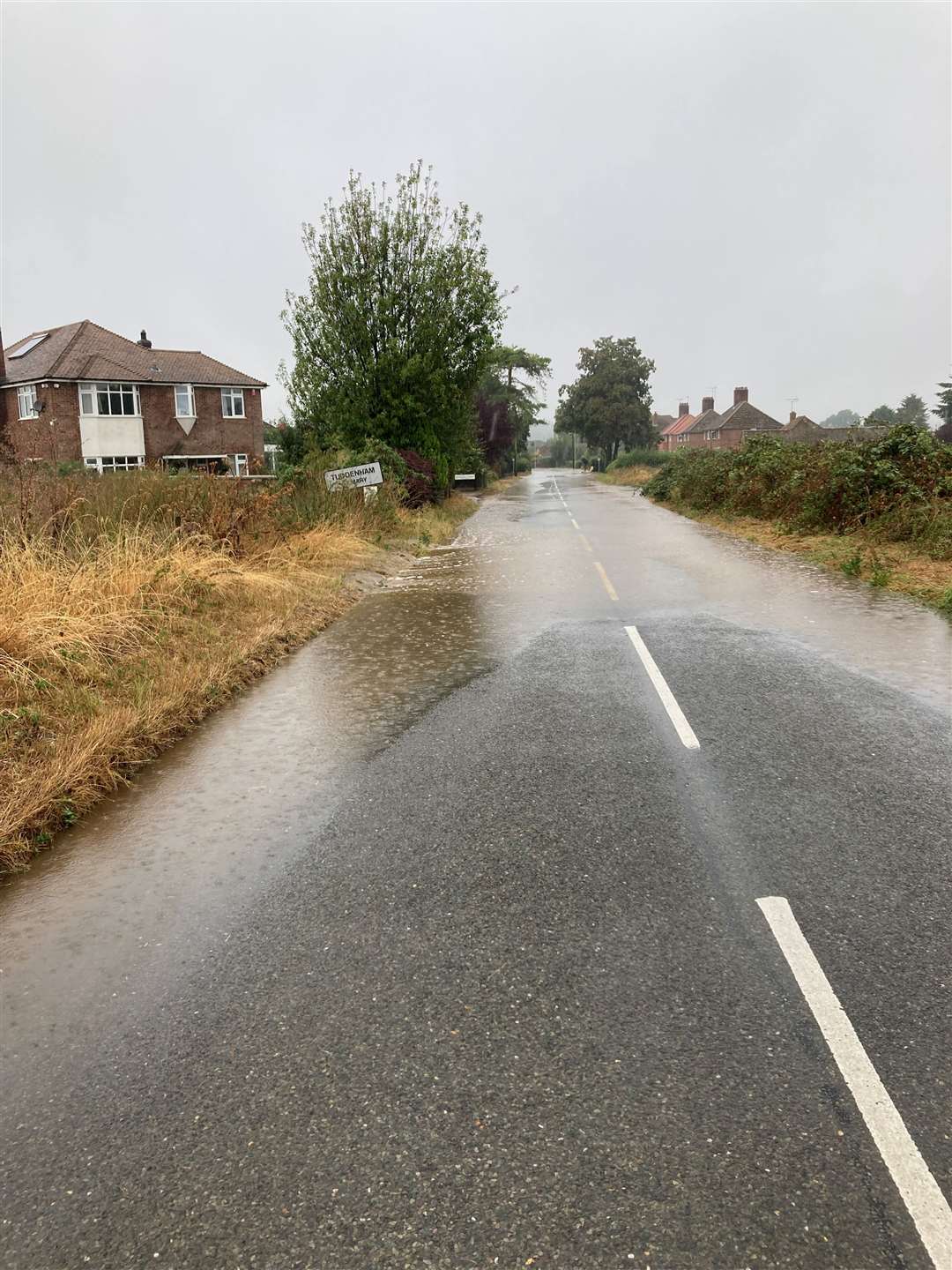 The road nearby Mr Palmer's Tuddenham St Mary home was left covered by water. Picture: Shaun Palmer