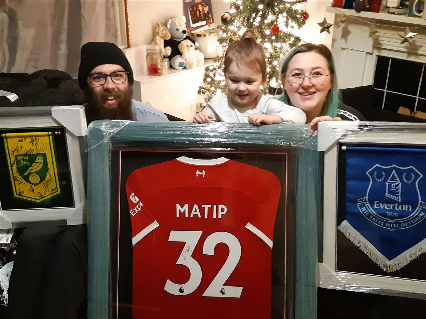 Megan Woods, Craig Pask and daughter Rosie with the signed football items. Picture: Kev Hurst
