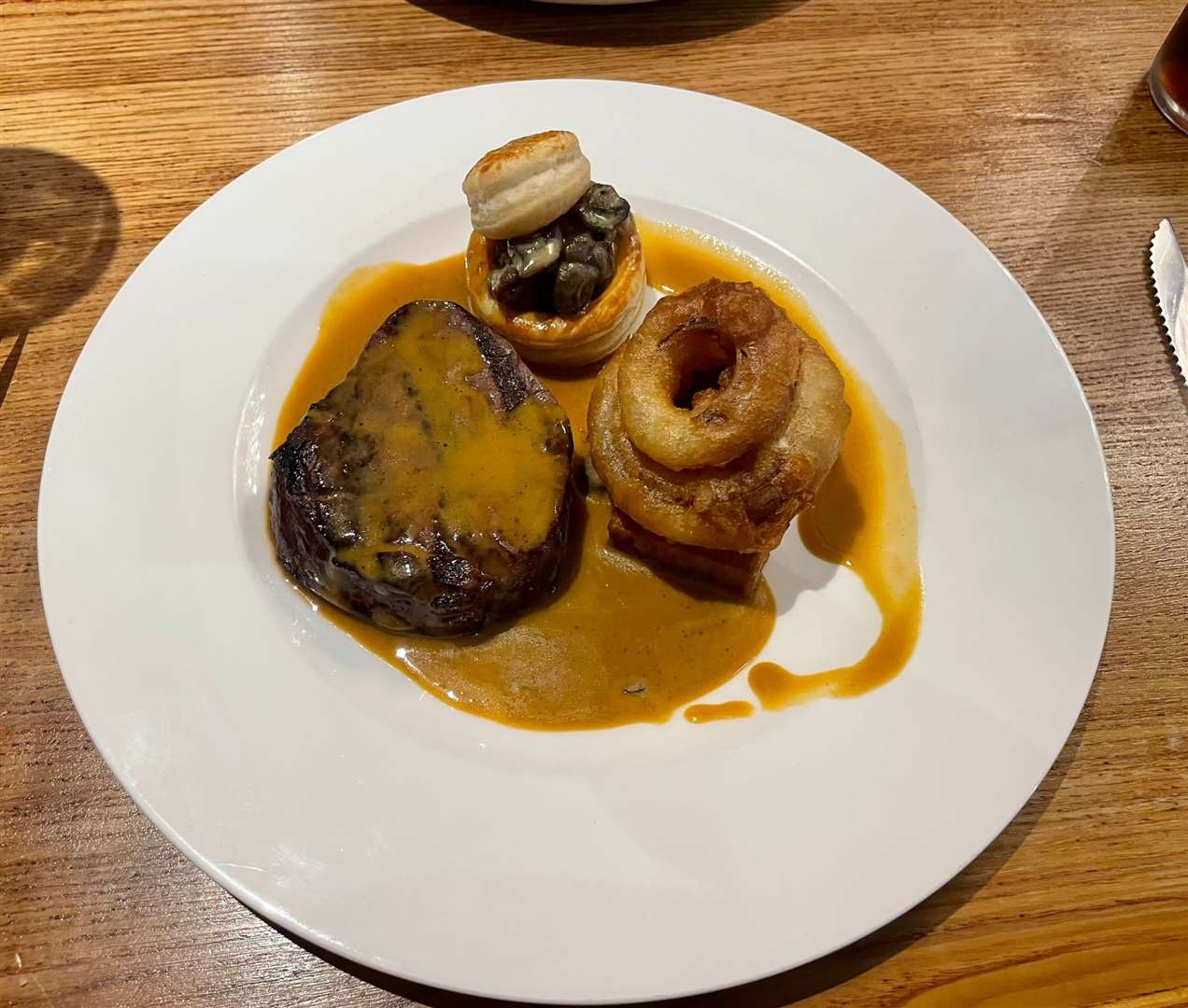 The fillet steak, garlic mushrooms, potato terrine and onion rings. Picture: Chantelle Hurst