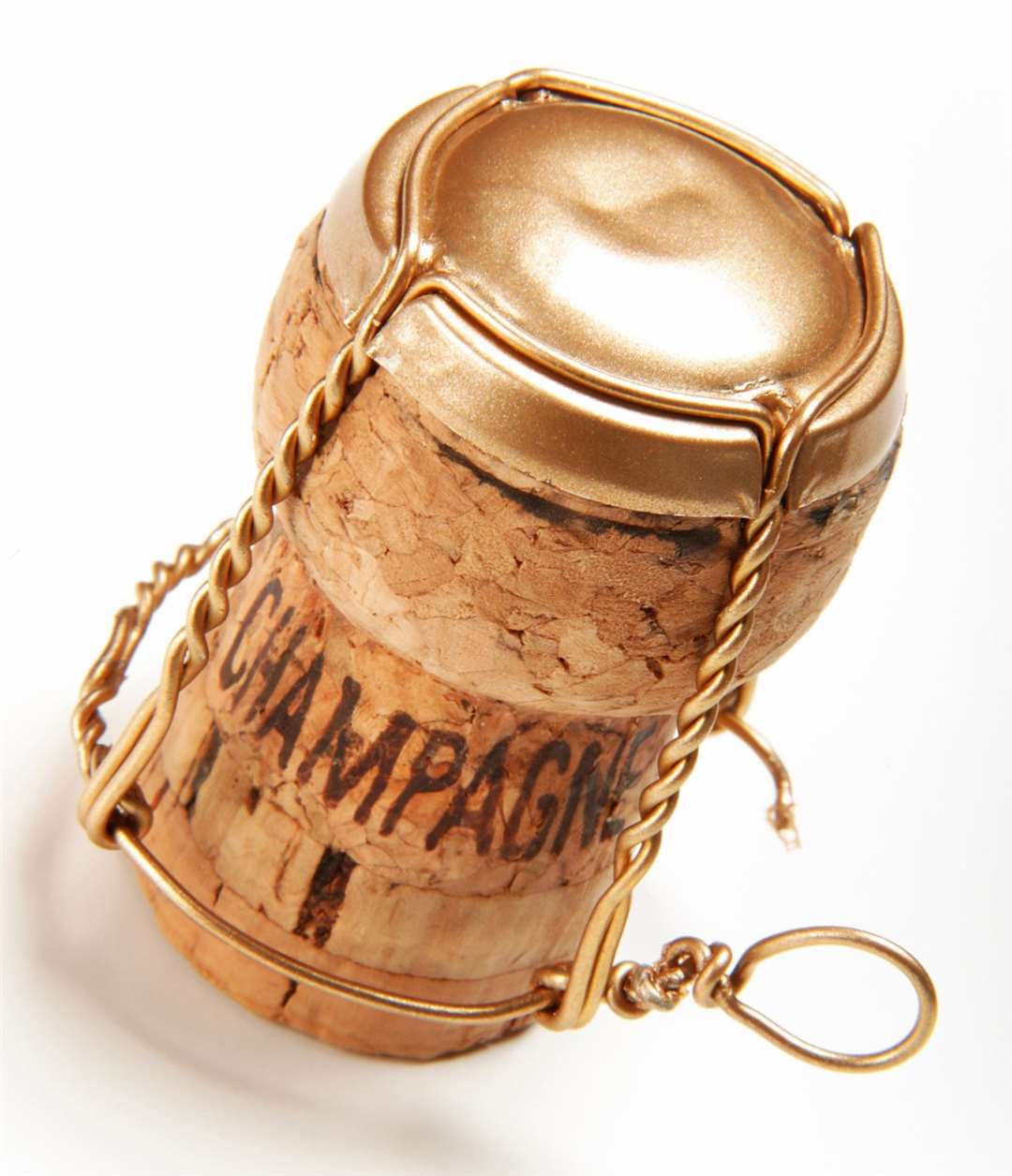 Gold champagne cork with the word champagne on it.