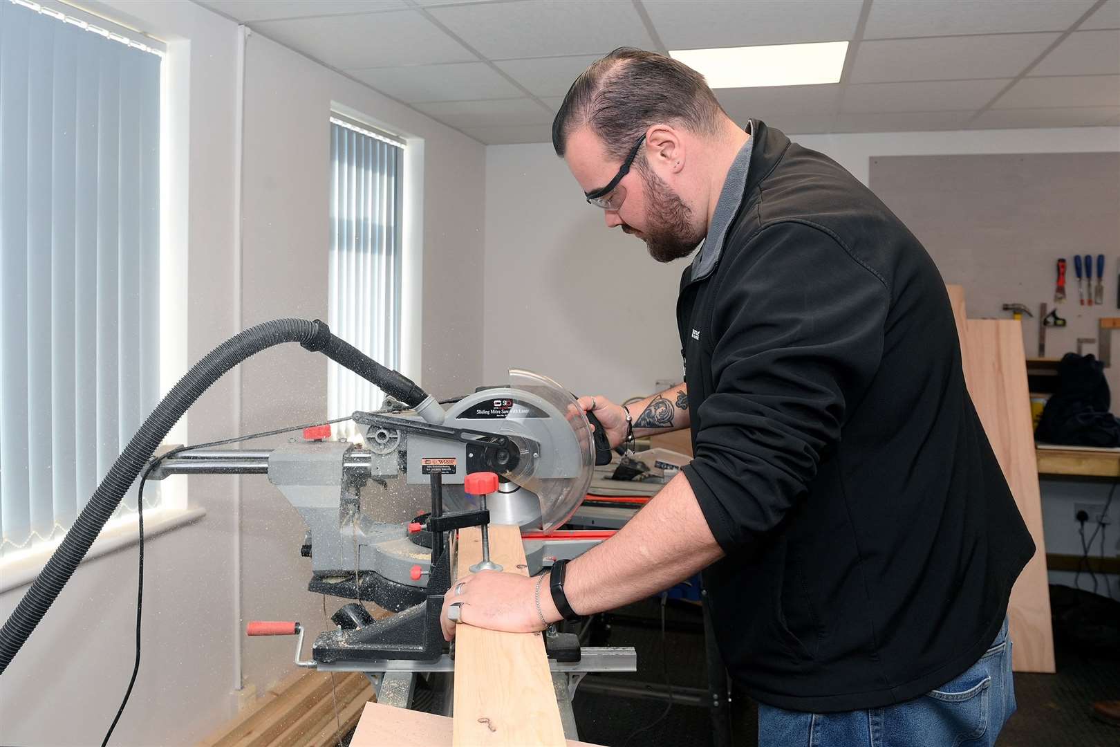 Ross Douglas, who also mentors in functional maths and English, in the wood workshop. Picture: Mecha Morton