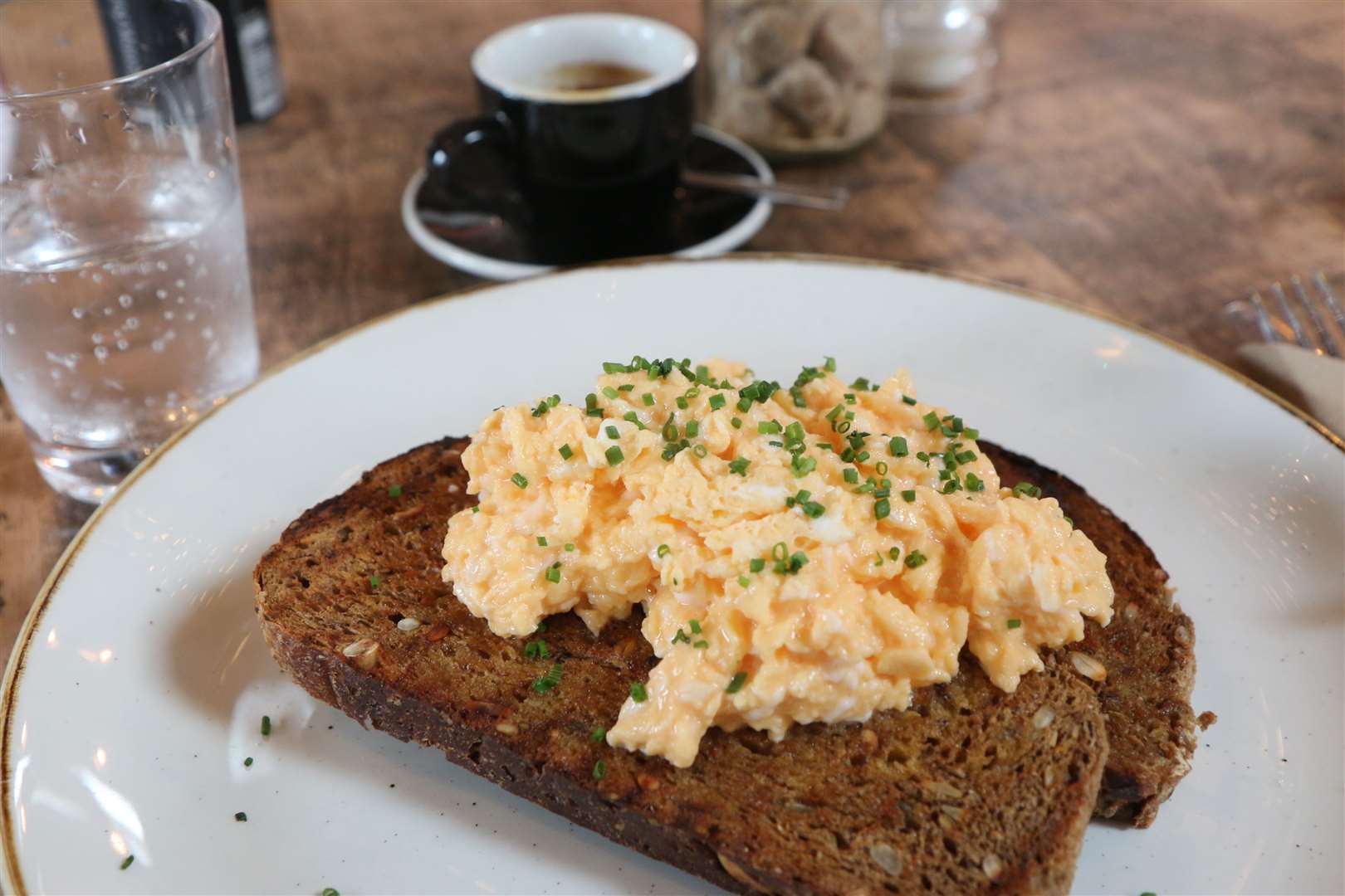 Scrambled eggs on toast and espresso