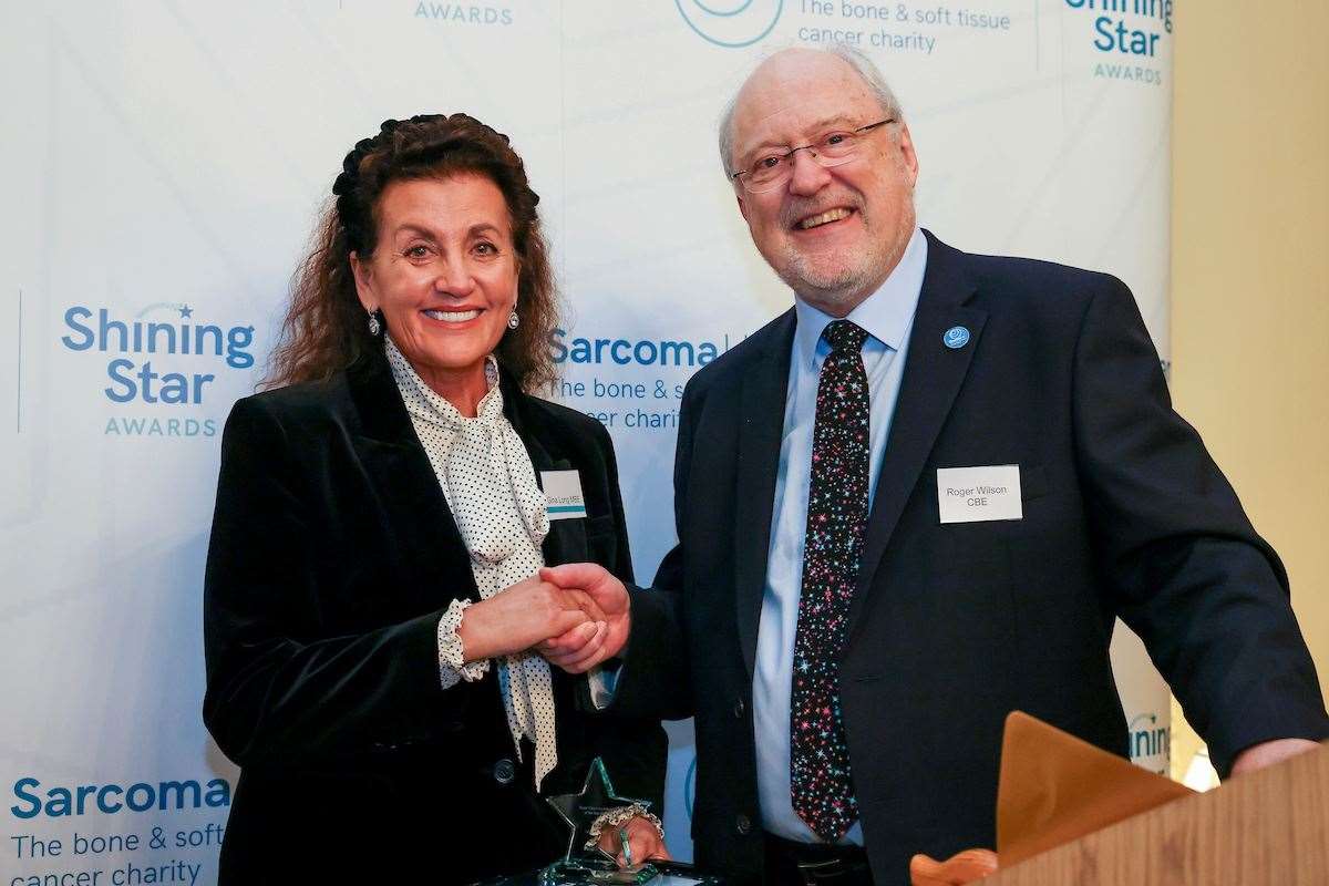 Gina Long MBE receiving her award from Sarcoma UK founder Roger Wilson CBE. Picture: Roy Arnold/ No 10. Downing Street